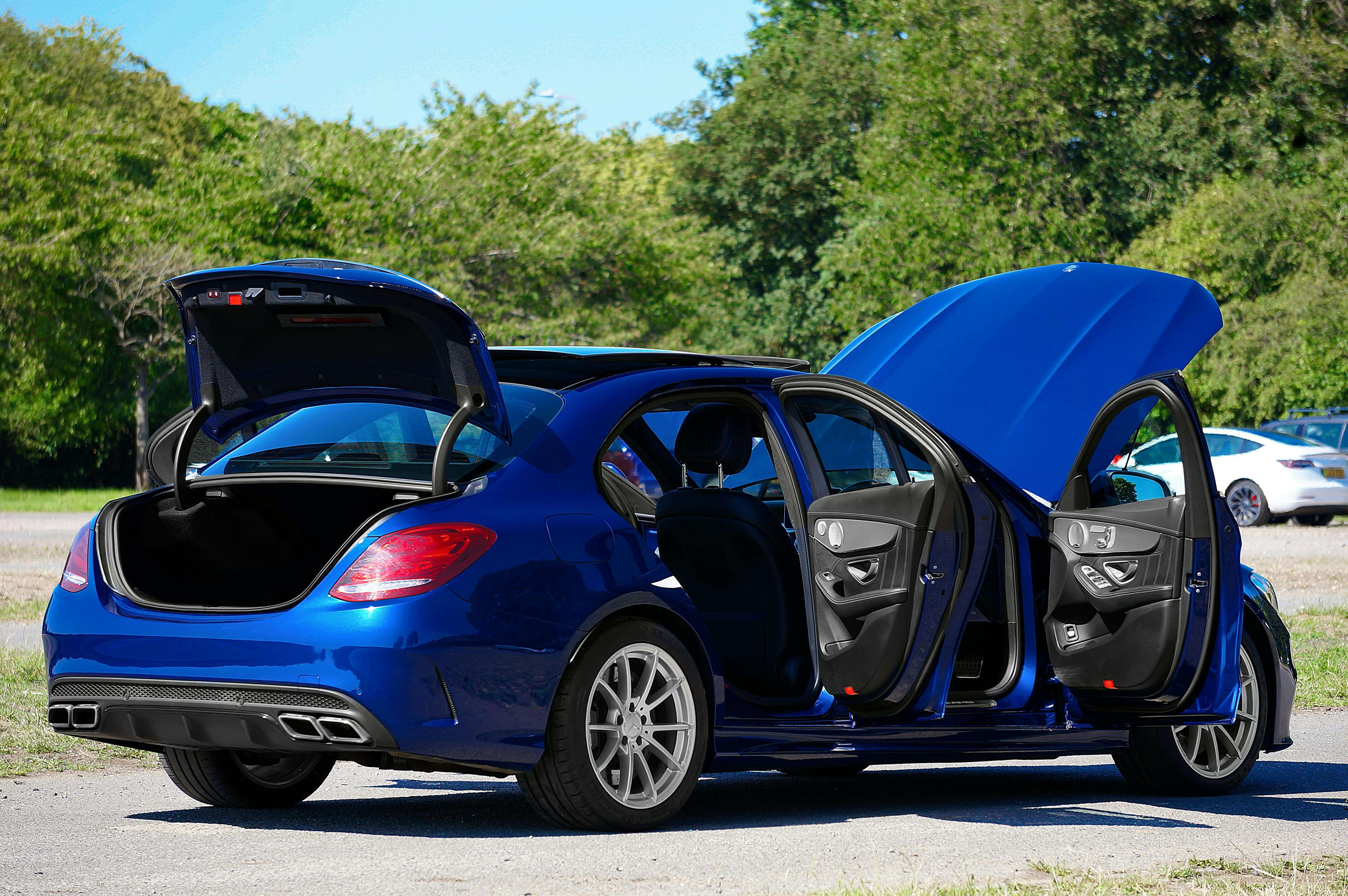 A car with its doors, trunk, and hood open